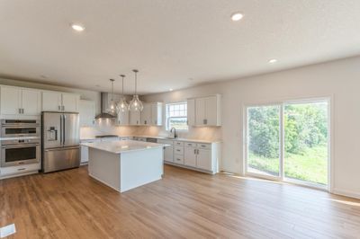 (Photo of an inventory home actual homes finishes will vary) Soaked in natural sunlight, the homes eat-in dining room has ample space for a dining table located in the heart of the home. | Image 3