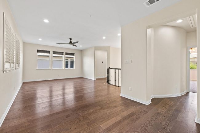 Empty room with ceiling fan, wood finished floors, and recessed lighting | Image 25