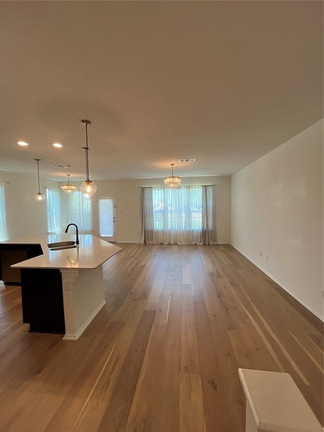 Kitchen featuring open floor plan, an inviting chandelier, plenty of natural light, and a sink | Image 8