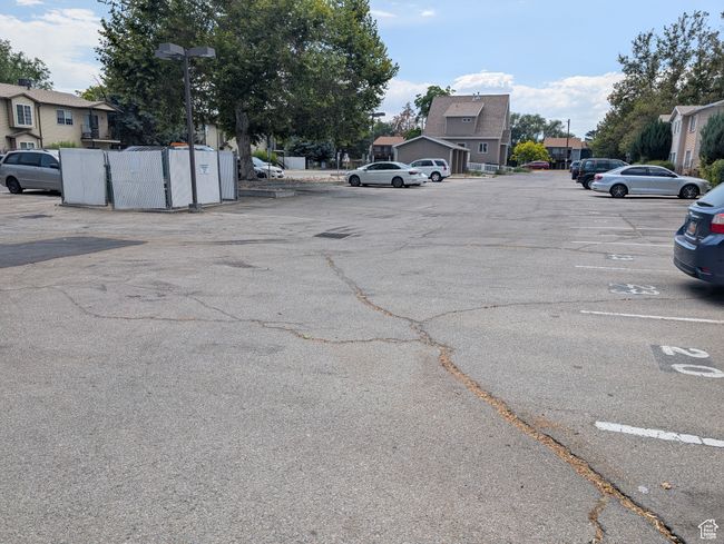 Uncovered parking lot featuring a residential view | Image 32