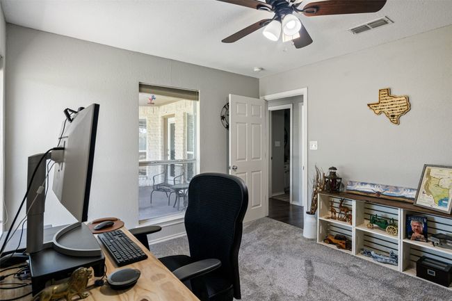 Office featuring a ceiling fan, visible vents, and carpet flooring | Image 21