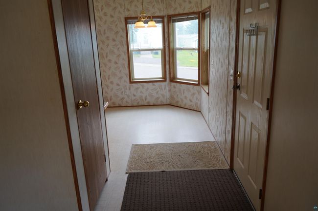 Interior space featuring wallpapered walls and tile patterned floors | Image 8