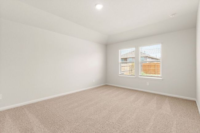 Bedroom featuring light carpet, and baseboards. | Image 13