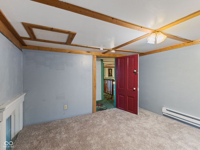 carpeted spare room with a baseboard heating unit | Image 29