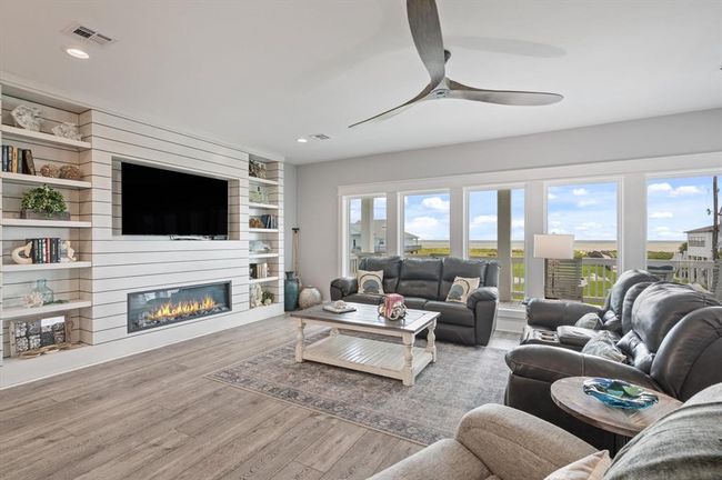 Open family room with an electric fireplace and gorgeous beach views | Image 12