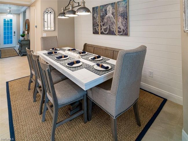 Tiled dining space with crown molding and wood walls | Image 8