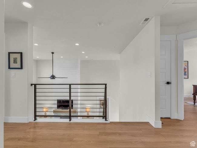 Corridor featuring wood finished floors, recessed lighting, baseboards, and an upstairs landing | Image 40