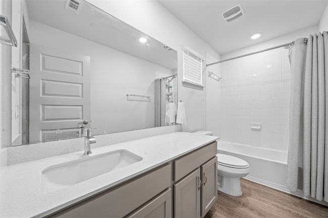 Full bathroom with visible vents, toilet, vanity, and wood finished floors | Image 27