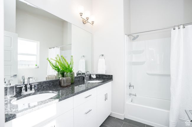 Bathroom featuring shower / bath combo, double vanity, and tile patterned floors | Image 14