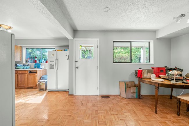 Foyer entrance featuring a textured ceiling, visible vents, and a wealth of natural light | Image 22