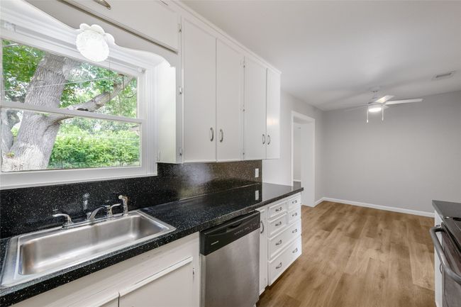 Kitchen featuring dishwasher, range, light wood-style floors, white cabinets, and ceiling fan | Image 23