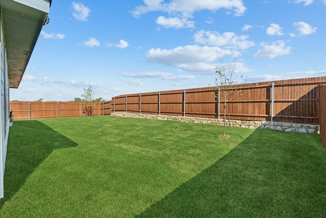 View of fenced backyard | Image 13