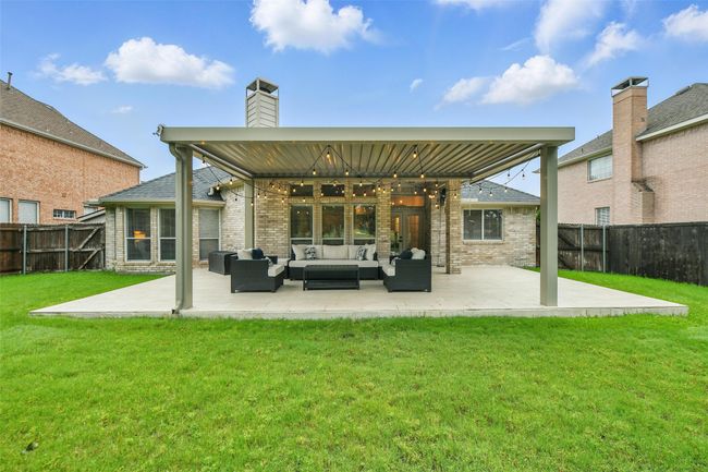 Rear view of house featuring an outdoor living space, a patio, and a fenced backyard | Image 29