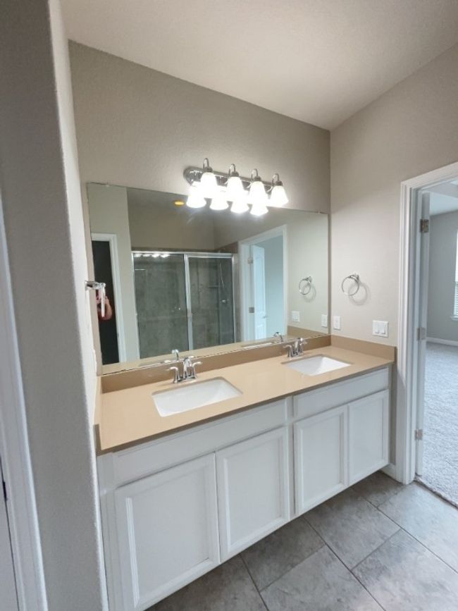 Bathroom featuring double vanity, a stall shower, and tile patterned flooring | Image 14