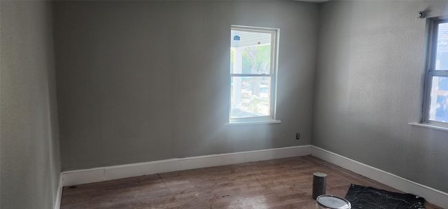 Unfurnished room with wood finished floors and baseboards | Image 14