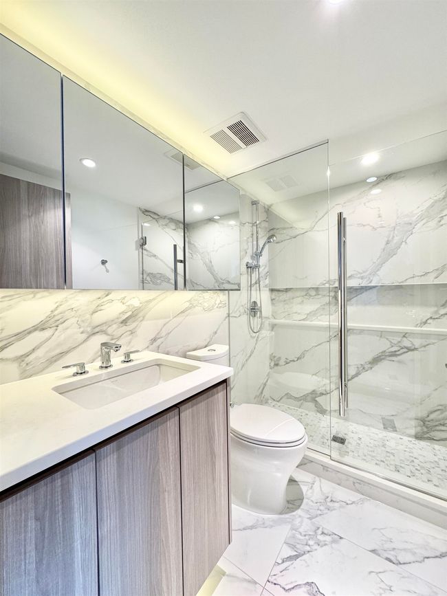 Bathroom featuring a marble finish shower, toilet, visible vents, recessed lighting, and marble finish floor | Image 11