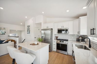 The white cabinets contribute to the open and airy feel of this home | Image 1