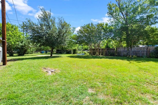 Step outside to enjoy a lush, green backyard—perfect for play, gardening, or entertaining. | Image 22