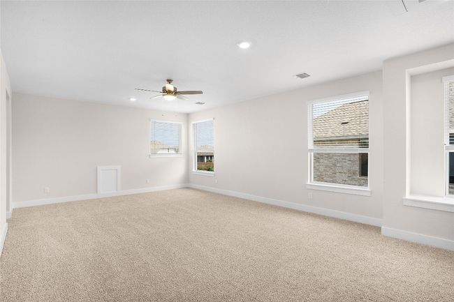 Spare room featuring light colored carpet, a ceiling fan, baseboards, and recessed lighting | Image 16