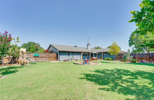 Fenced backyard with a playground | Image 34