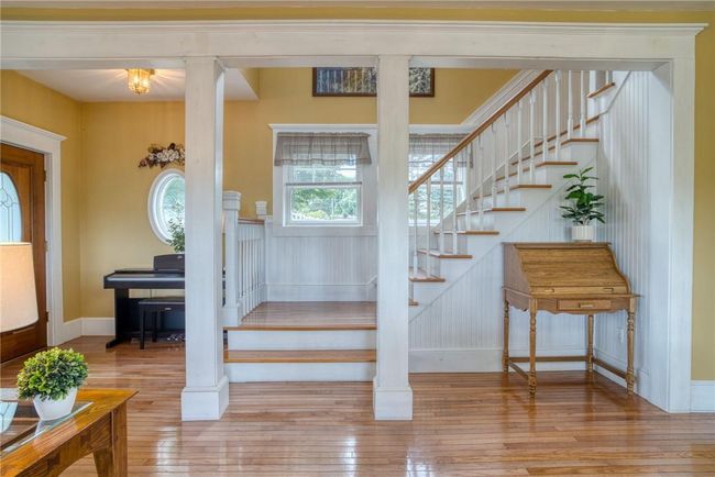 Stairs featuring decorative columns and light hardwood / wood-style floors | Image 19