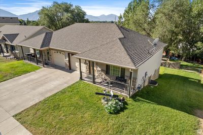 View of front of home with a mountain view, a garage, a front lawn, and covered porch | Image 1