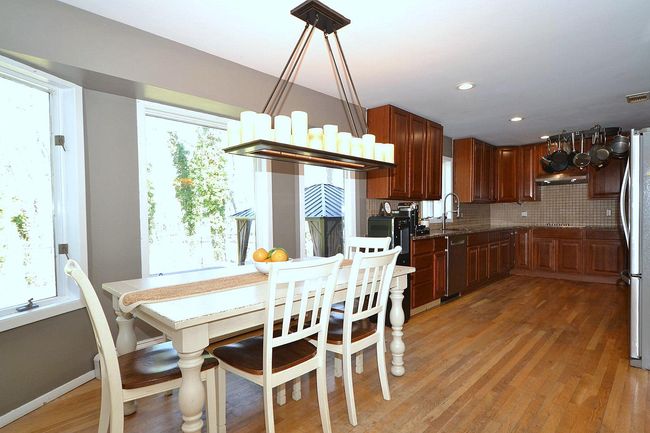 Dining area with a wealth of natural light, light wood-type flooring, and baseboards | Image 7