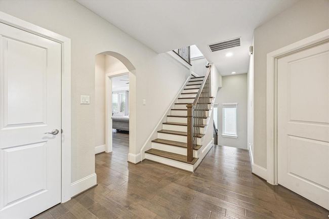 Spacious second-floor landing between the primary bedroom, laundry room, and three secondary bedrooms on this floor. | Image 18
