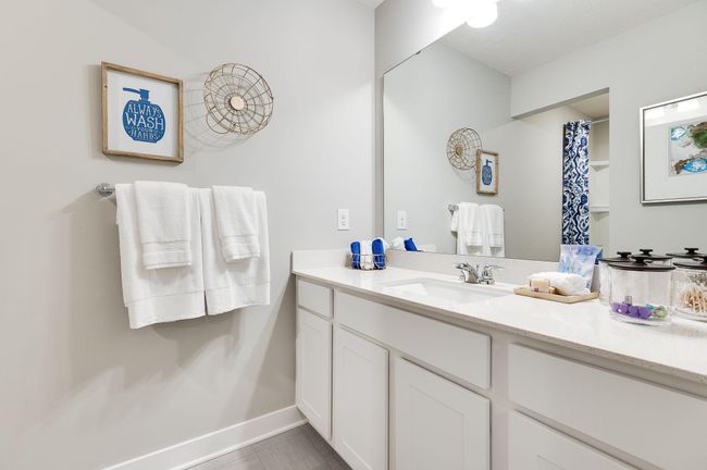 Hall bathroom with a shower and toilet tucked away from the oversized vanity sink area. Previously built model home, finishes, selections, and colors to vary from future built home. | Image 27