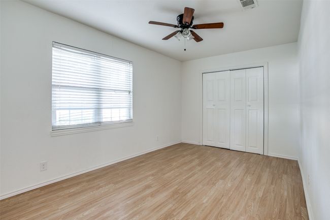 Unfurnished bedroom featuring wood finished floors, a closet, and ceiling fan | Image 17