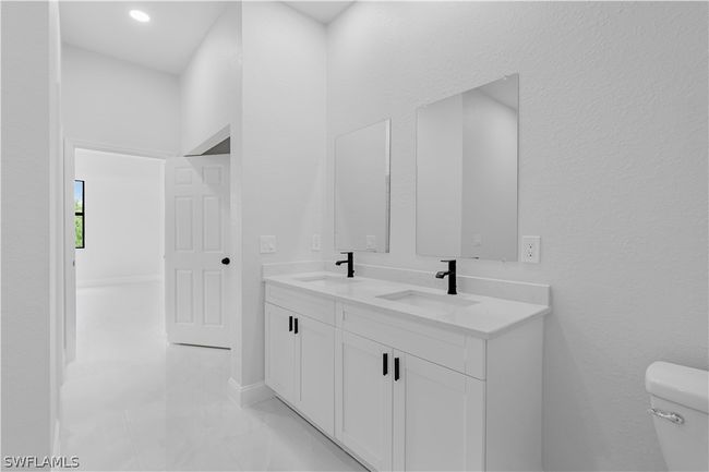 Bathroom featuring dual bowl vanity, tile flooring, and toilet | Image 42