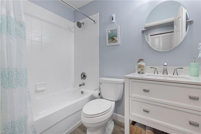 Full bathroom with shower / bathtub combination with curtain, vanity, and toilet | Image 19