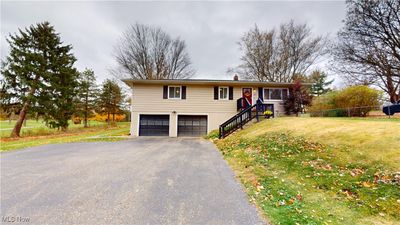 View of front of house with a front yard and a garage | Image 1