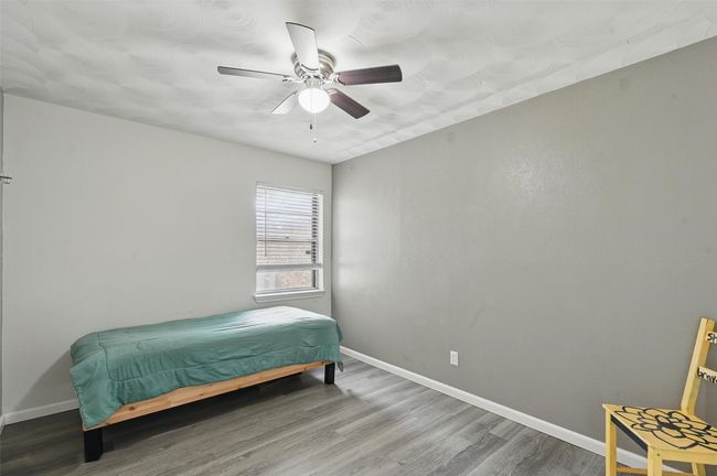 Bedroom featuring wood finished floors, baseboards, and ceiling fan | Image 17
