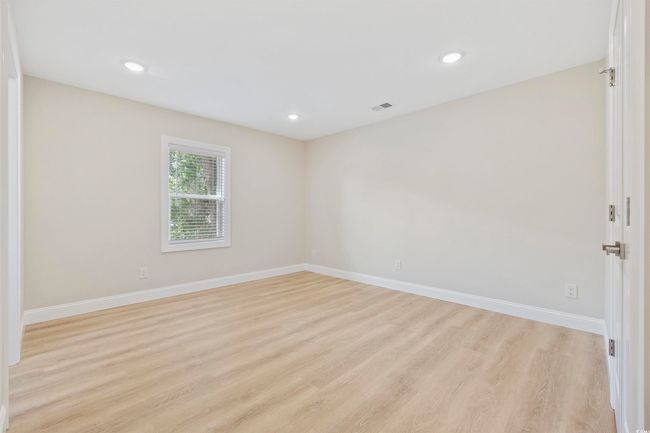 Empty room with light wood finished floors, baseboards, and recessed lighting | Image 13