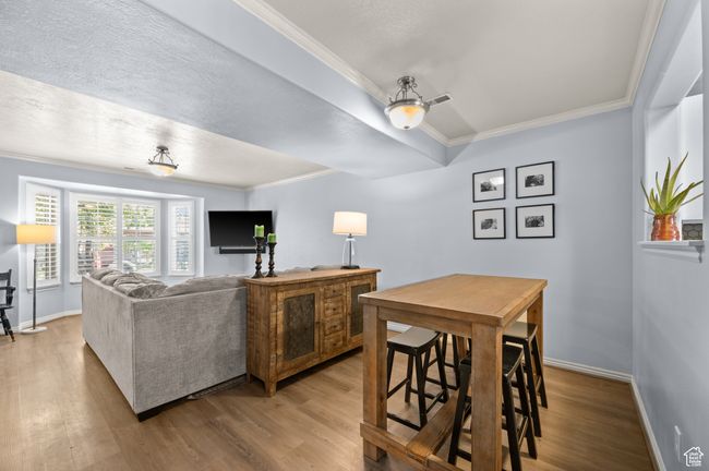 Living room featuring wood finished floors and crown molding | Image 8