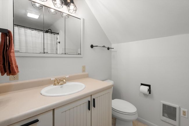 Full bath with toilet, vanity, heating unit, and vaulted ceiling | Image 29