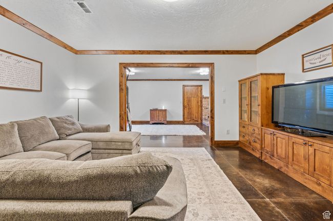 Living room featuring ornamental molding and a textured ceiling | Image 37