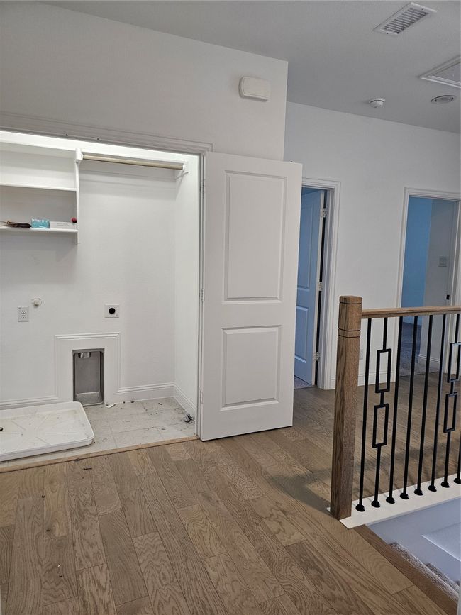 Washroom with electric dryer hookup, wood finished floors, hookup for a washing machine, and attic access | Image 10