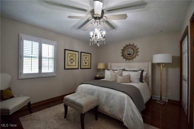 Bedroom featuring baseboards, wood finished floors, and ceiling fan | Image 14