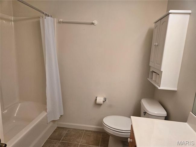 Full hall bath featuring vanity, shower / bathtub combination with curtain | Image 11