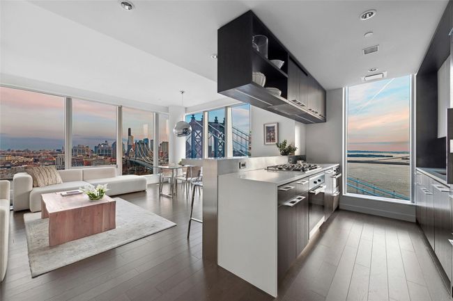 Kitchen with dark wood-style floors, light countertops, visible vents, modern cabinets, and a peninsula | Image 4