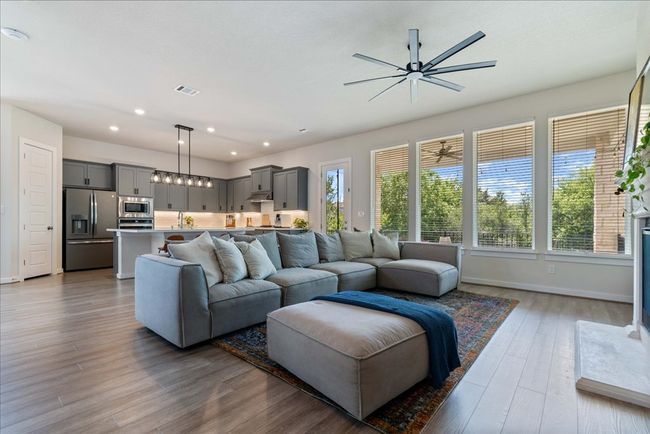 Living area featuring visible vents, baseboards, ceiling fan, recessed lighting, and wood finished floors | Image 15