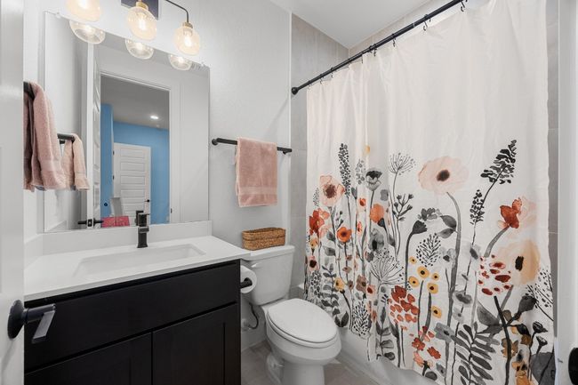 Bathroom with vanity and a shower with curtain | Image 19