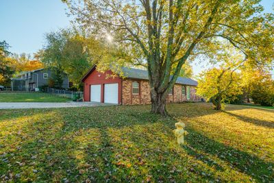 View of front of house with a front yard and a garage | Image 1