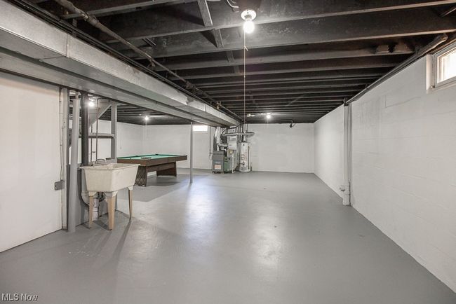 Basement featuring billiards, gas water heater, and sink | Image 29