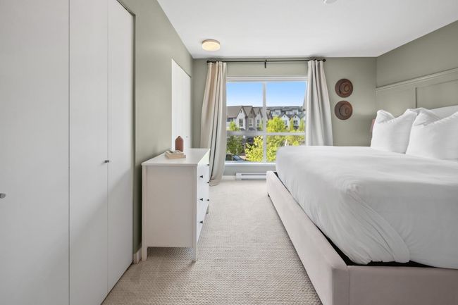 Bedroom featuring light colored carpet and baseboard heating | Image 22
