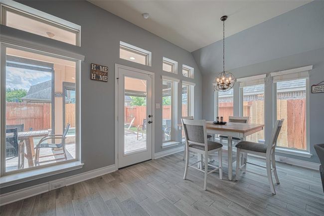 Light & Bright breakfast nook is surrounded by windows. | Image 22