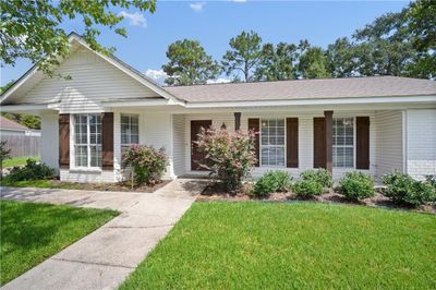 Ranch-style house with a front lawn and a porch | Image 3