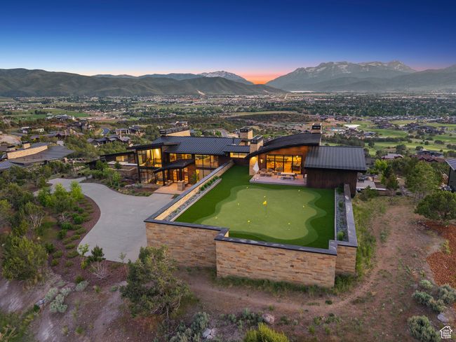 Back of house at dusk featuring a mountain view and a putting green | Image 118